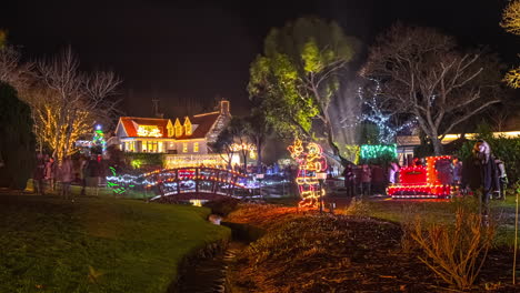 Time-lapse-shot-of-pedestrian-and-kids-walking-and-strolling-on-in-christmas-decorated-park-and-city-of-Saint-Peter-Port-at-night,Guernsey