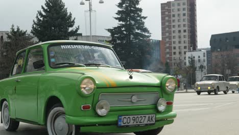 Convoy-of-Eastern-European-Trabi-Trabants-retro-classic-cars-drive-through-city-streets