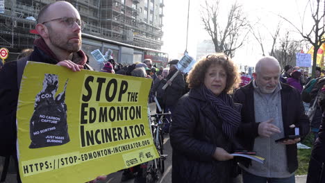 A-man-in-a-crowd-holds-a-yellow-protest-placard-that-reads,-“Stop-the-Edmonton-Incinerator”