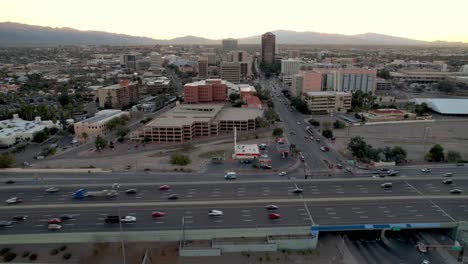Aerial-push-in-over-traffic-and-interstate-into-Tucson-Arizona-Skyline
