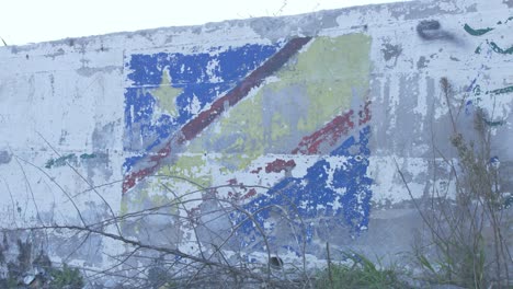 Congolese-flag-graffiti-flaking-paint-in-old-Moria-refugee-camp