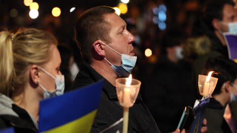 Man-With-Lit-Candle-Singing-Religious-Song-During-Vigil-For-Peace-In-Ukraine-Held-In-Leiria,-Portugal-At-Night