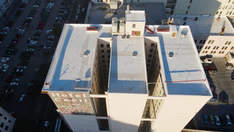 Aerial-view-overlooking-the-Haunted-Cecil-hotel,-golden-hour-in-Los-Angeles,-USA