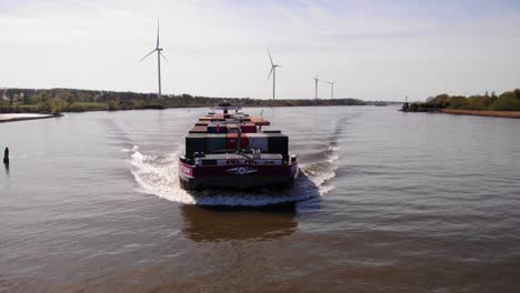 Aerial-View-From-Forward-Bow-Of-Petran-Cargo-Ship-Along-Oude-Maas-With-Windmills-Seen-In-Background