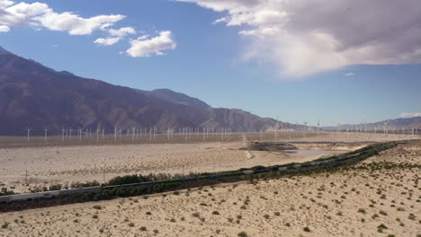 Cargo-freight-train-near-Palm-Springs-with-windmill-farm-in-distance