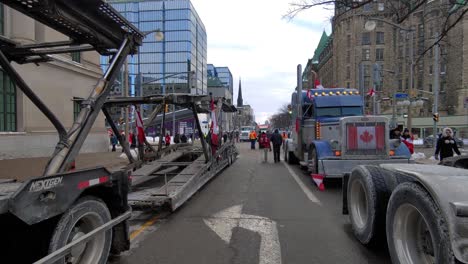 Freedom-Convoy-2022-truck-lineup-and-signage-protesting