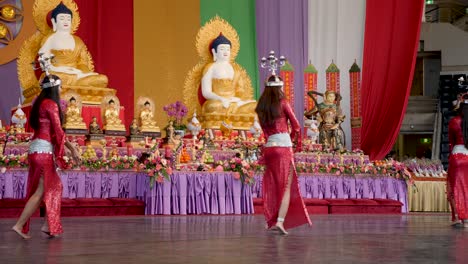 Indonesian-women-dancing-belly-dance-with-candle-holder-on-head-during-Buddha-Birthday-Festival,-Brisbane-2018