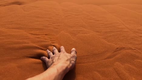 Slow-motion-shot-of-a-man's-hand-moving-through-sand-in-the-Wadi-Rum-Desert,-Jordan