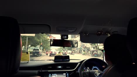 View-from-the-back-seat-of-a-tourist-taxi-in-heavy-traffic-in-Bangkok,-Thailand