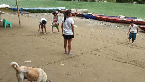 rural-children-drawing-lines-on-a-hard-soil-using-sticks