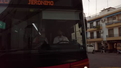 City-Bus-Turns-Corner-of-Tiny-Alley-in-Spain,-Slowmo-Tracking-Pan