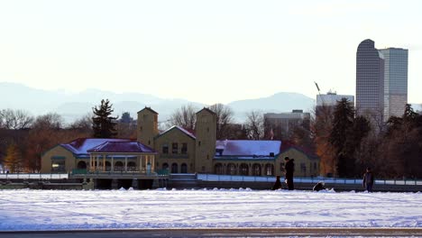 Weekend-in-the-park-against-Denver-skyline-and-mountains