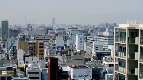 Wide-panorama-of-the-hotel-area-of-the-city-near-downtown-with-Tokyo-Inn-in-the-middle,-Handheld-establishing-shot