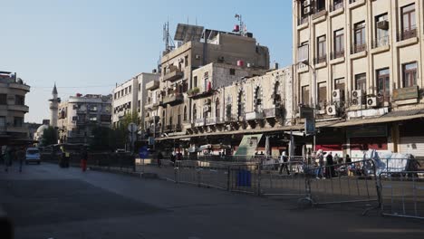 Steady-shot-of-different-establishments-in-the-city-as-people-and-vehicles-pass-by