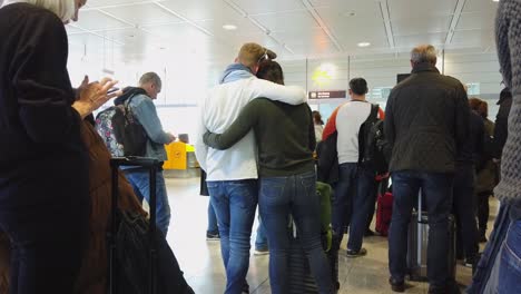 Travellers-line-up-patiently-to-board-plane-at-airport-terminal-gate