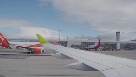 Air-Baltic-plane-taxiing-on-the-runway-upon-landing-at-an-airport-in-Malaga