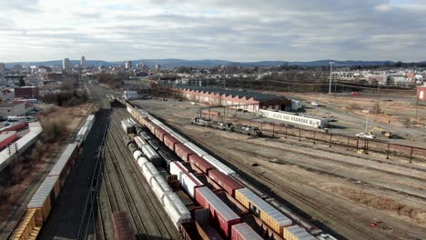 Wide-angle-aerial-pullback-drone-shot-reveals-Reading-Railroad-yard,-switching-station-in-Berks-County,-PA