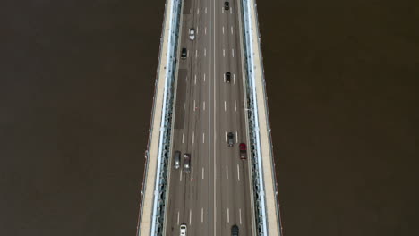 Aerial-overhead-view-of-Philadelphia-Ben-Franklin-Bridge-and-skyline-in-the-summer-with-cars-and-traffic-driving-on-the-road-to-reveal-buildings