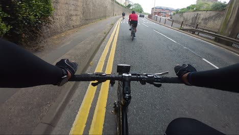 POV-View-Riding-On-The-A412-Road-Under-Train-Bridge-In-Rickmansworth-With-Other-Cyclists-In-Front