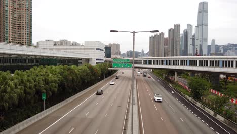 Traffic-passing-in-downtown-Hong-Kong,-Low-angle-aerial-view