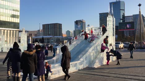 Excited-Children-Playing-On-A-Slide-Ice-Sculpture