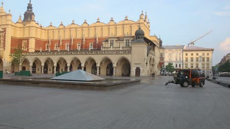 Cleaner-vehicle-on-empty-Krakow-Main-Square-works-by-historic-Cloth-Hall
