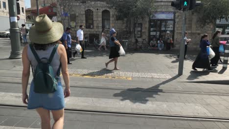Tourist-woman-in-summer-outfit-cross-the-street-of-Jerusalem