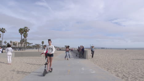 Walking-along-the-bike-path-that-runs-between-Santa-Monica-Venice-Beach-in-Los-Angeles,-California