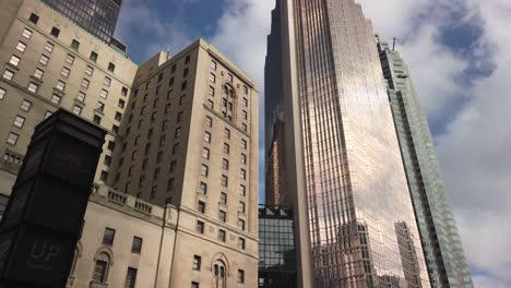 Slow-wide-tilt-down-from-majestic-Royal-Bank-Tower-and-Royal-York-Hotel-to-the-street-below,-showing-street-life