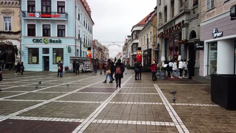 Brasov,-Romania---7-December-2019-:-People-walking-on-the-Old-Square-on-day-time,-Christmas-Fair-in-Brasov-,-Winter-Season,-Christmas-decorations