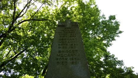 Stone-crucifix-tombstone-spooky-cemetery-pan-shot