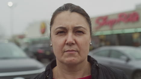 Woman-takes-off-the-white-face-mask-in-the-parking-lot