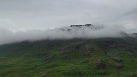 Aerial-shot-of-a-mountain-with-low-clouds-at-the-peak,-in-the-English-Lake-District