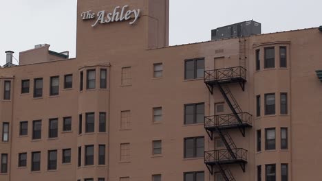 Slow-tilt-up-to-roof-of-historic-triangular-Detroit-Ashley-Apartments