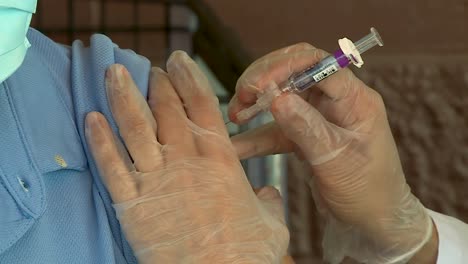 CLOSE-UP-OF-DOCTOR-GIVING-A-PATIENT-A-FLU-SHOT-DURING-PANDEMIC