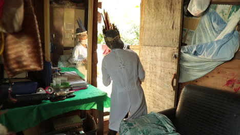 Amazonian-tribal-healer-volunteering-as-a-COVID-19-nurse,-leaving-home-with-a-small-box-of-medical-supplies