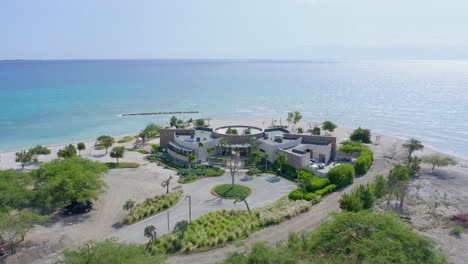 Aerial-view-over-the-Puntarena-resort,-at-a-shallow-turquoise-lagoon,-in-Bani,-Punta-Arena,-Domienican-republic,-Caribbean-America---dolly,-drone-shot