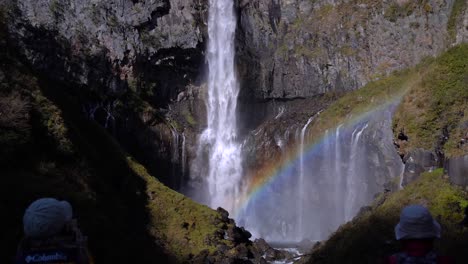 Push-in-towards-Japanese-person-wearing-facemask-taking-selfie-in-front-of-incredible-waterfall