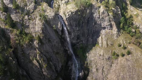 Gorgeous-aerial-shot-of-a-large-waterfall-on-the-cliffs-of-a-canyon-in-France