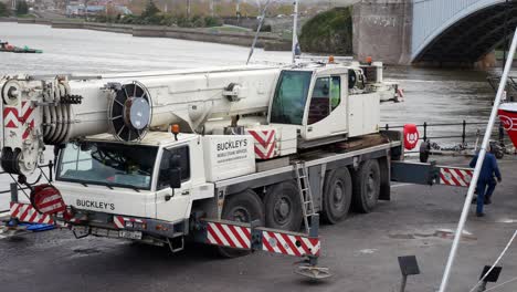 Hydraulic-crane-vehicle-moving-support-legs-on-Conwy-Wales-harbour