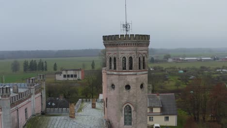 Orbiting:-Aerial-view-on-old-Neo-Gothic-Vecauces-city-manor-main-tower