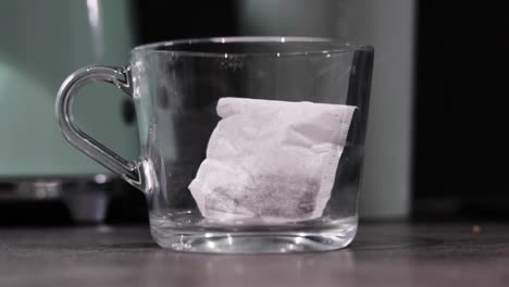 A-tea-bag-being-dropped-in-a-glass-mug