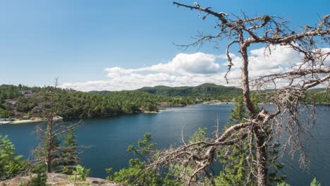 Time-lapse:-overlooking-Norwegian-highland-blue-lake,-boats-on-water