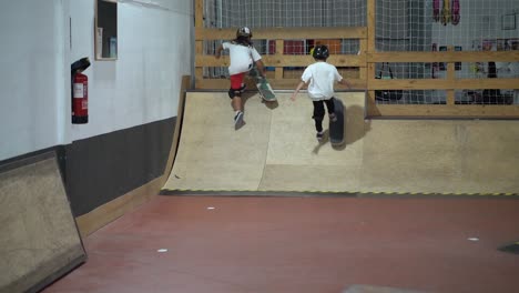 Two-young-skateboarder-driving-up-the-ramp-in-slow-motion