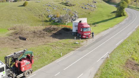 Aerial-view-of-men-fixing-a-long-lorry-truck-on-the-side-of-the-road
