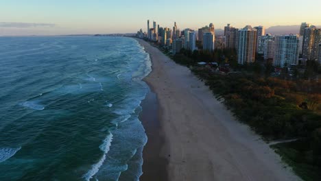 Flying-south-along-beautiful-Gold-Coast-beaches,-sunset,-drone-footage