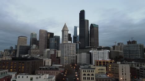 Slowly-pulling-back-from-the-South-Seattle-City-skyline,-early-morning,-overcast,-aerial