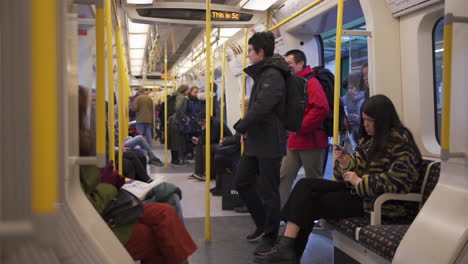 Passengers-Entering-in-Train-on-London-UK-Underground-Metro-System,-Slow-Motion