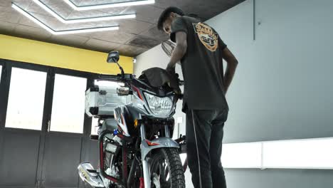 Male-Using-Fibre-Cloth-To-Clean-Honda-CBF150F-Cockpit-Inside-Garage