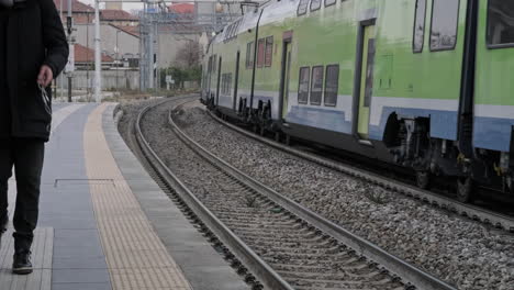 A-Man-Walking-Near-the-Train-Rails-When-the-Train-Arriving-at-Station